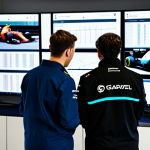 A diverse group of professional Formula 1 team members, including a female strategist and male engineers, meticulously reviewing data on large screens within a high-tech pit garage. They are wearing modest team uniforms, fully clothed, and engaged in a focused, collaborative discussion. The background features blurred F1 equipment and a glimpse of a modern race car. Natural pose, perfect anatomy, correct proportions, well-formed hands, proper finger count, natural body proportions, professional photography, high quality, realistic, safe for work, appropriate content, professional.